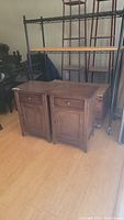 Two matching wood grain nightstands with drawer and cupboard, front and top views.