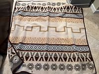 Top view of the full blanket spread on the floor showing the full pattern and coloration.