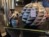 Three pottery pieces on kitchen counter with tape measure showing size