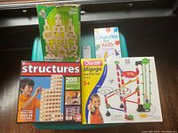 Photo showing overall boxed lot with wooden blocks set, Charades for Kids, and Migoga marble run boxes