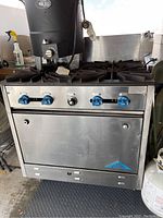 Front view of stainless steel range with oven door closed and control panel visible