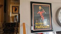 Poster of a figure twirling pasta with text Maccheroni Pianigiani in black frame