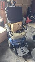 Front angled view of wheelchair with cushion and battery box