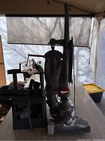 Front-side view of vacuum cleaner with accessories caddy on table