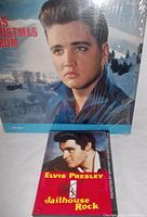 Elvis Presley Christmas LP and Jailhouse Rock CD together, LP in shrink wrap with winter background portrait, CD below.