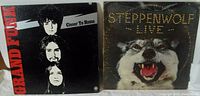 Both vinyl LP albums shown side by side: Steppenwolf Live on right with snarling wolf cover, Grand Funk Closer To Home on left with three band member heads stacked vertically on black background.