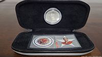 Collector's set inside black velvet-like lined rectangular presentation case with Bobby Hull medallion and two NHL All-Star stamps from 2001 Canada Post.