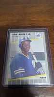 Front of Ken Griffey Jr 1989 Fleer Rookie card showing player portrait in Mariners uniform with bat and branding