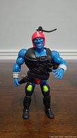 Front view of Kronis Masters of the Universe action figure standing upright, showing blue skin and red helmet.