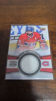 Front of P.K. Subban hockey card showing image of player in Montreal Canadiens uniform, embedded circular jersey swatch, and branding.