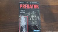 Front of card packaging with Predator figure in clear plastic blister showing invisible appearance, branding and background.