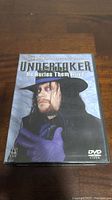 Front cover of WWE Undertaker He Buries Them Alive DVD featuring portrait of Undertaker.