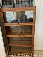 Full front view of four stacked sections showing wood grain and glass doors