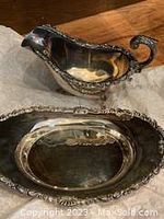Birks Regency Deluxe silver gray dish and oval shaped dish photographed together showing ornate silver plating detail.