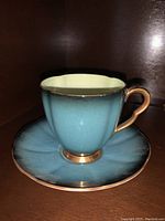 Carleton Ware teacup and saucer in greenish-blue with gold trim