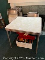 Table with folded chairs behind