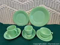 Set of 8 Fire King Jadeite pieces displayed including two plates, a teacup and saucer, egg cup, two bowls, and a mug.