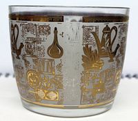 Close-up photo showing the intricate gold and white decorative design on the glass surface.