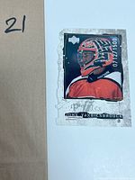 Photo showing John Vanbiesbrouck hockey sports card with some edge wear and scraping.