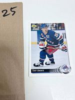 Tony Amonte hockey card front showing player in blue Rangers uniform skating with puck.