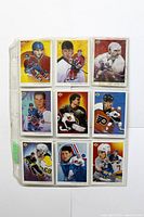 Front side of nine vintage hockey trading cards in a plastic sheet
