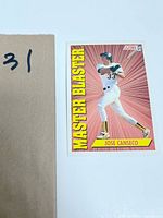 Photo showing front side of the 1991 Score baseball card featuring Jose Canseco titled Master Blaster with red starburst background.
