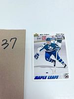 Full view of the Mike Foligno hockey card showing player in blue Toronto Maple Leafs uniform skating on ice with a stick.