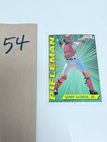 Photo of 1991 Score baseball card of Sandy Alomar Jr. in catcher gear with green burst background and 'Rifleman' text