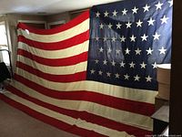 Full view of large 48-star wool flag hanging indoors
