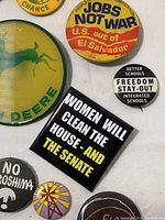 Close-up group of assorted pinback buttons on white background