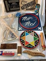 Photo of entire lot showing Autobridge board, Puff Pool, Chinese Checkers, dominoes, Game of Graces, shuttle puzzle, and other items arranged on a white surface.