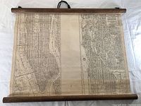 Full view of the sepia-toned map spread out between two wooden rods, showing overall dimensions and mounting style