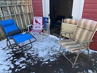 Lot showing all five patio seating items outdoors on asphalt with some snow, including the blue lounger and four varied patio chairs.