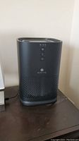 Full view of the Medify Air MA-14 air purifier in black showing its shape, venting design, and power cord.
