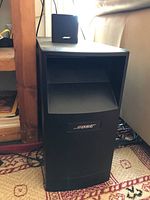 Photo showing Bose Acoustimass subwoofer unit with Bose branding.