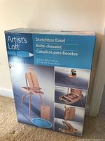 Photo of the packaging box showing product brand, name, and images of the easel in various configurations.