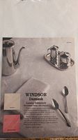 Photo showing unopened Windsor Damask luxury tablecloth packaging depicting silver tea set and spoon on white damask fabric.