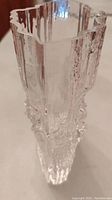 Top angled view showing clear glass with irregular ridges and bubble texture, artistic sculptural form.