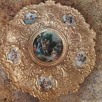 Top-down view of the entire gilt metal wall plaque showing the Rococo design and all porcelain inserts.