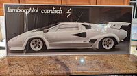 Front view of white Lamborghini Countach print in white metal frame