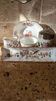 Photo showing all five items including the long mint/candy dish at front and the covered egg coddler with metal lid on right side, arranged on a countertop.