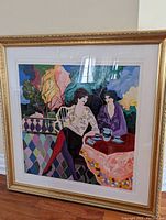 Full front view of framed serigraph leaning against wall, showing overall appearance and frame.
