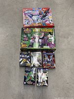 Photo showing all seven boxed items laid on the ground to display included figures and packaging.