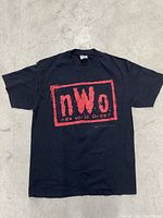 Full front view of black t-shirt with red NWO logo and text.