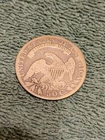 Reverse side of the 1831 half dollar coin showing the eagle with shield and inscriptions.