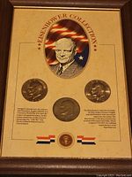 Framed display titled 'Eisenhower Collection' with three coins and portrait of Dwight D. Eisenhower.
