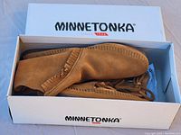 Pair of Minnetonka brown suede moccasin boots in original branded box.
