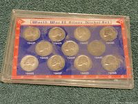 Front view of the World War II silver nickel set showing coins from 1942 to 1945 in a plastic display holder with red and blue insert.