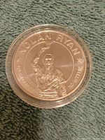 Obverse side of the coin showing Nolan Ryan with text noting seven career no-hitters