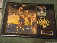 Full view of the signed Charles Barkley Phoenix Suns action photo plaque with cards and emblem on a dark background.